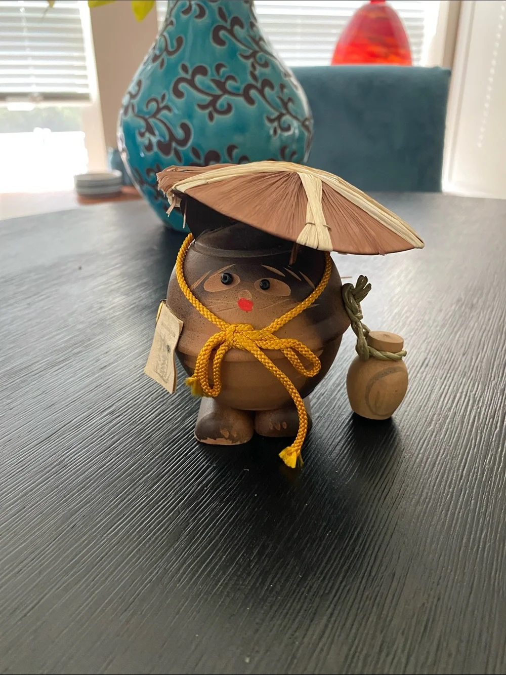 Vintage Japanese wooden folk art figurine depicts a tanuki (Japanese raccoon dog